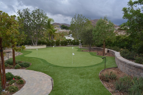 Augusta Synthetic grass golf green in a landscaped backyard