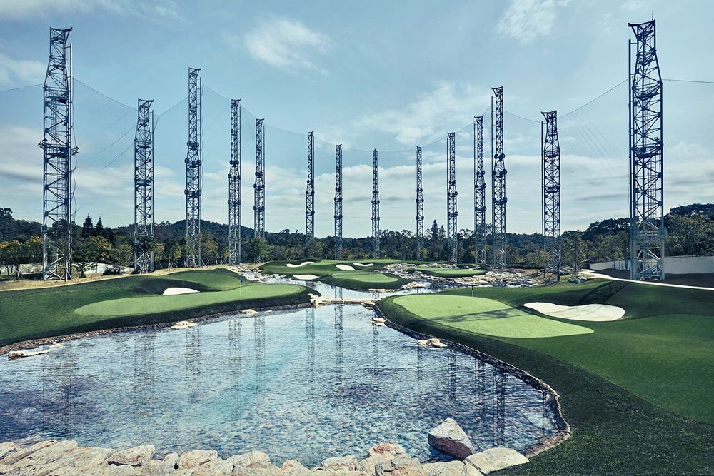 Augusta Synthetic grass golf course with water and tall metal towers